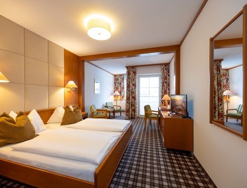 Gemütlich eingerichtetes Doppelzimmer im Hotel zum Mohren mit Sitzecke, Schreibtisch und Balkon.